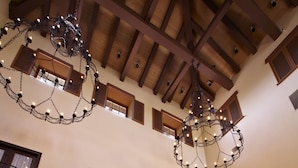 A spacious lobby with high ceilings, a chandelier, and a patterned carpet. - Omni Rancho Las Palmas Resort & Spa (Rancho Mirage)