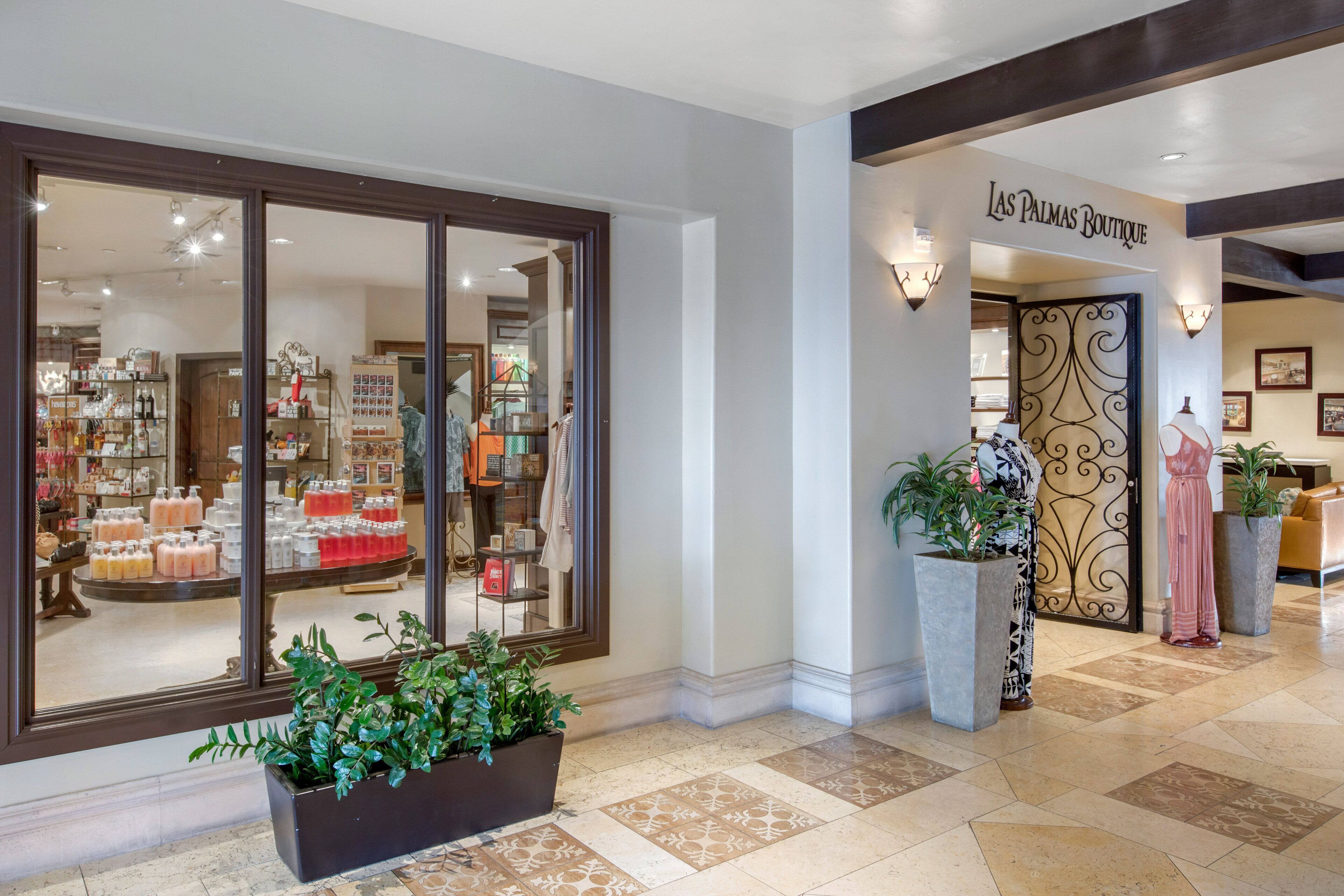 A boutique store with a large glass window display and a sign reading "Las Palmas Boutique".