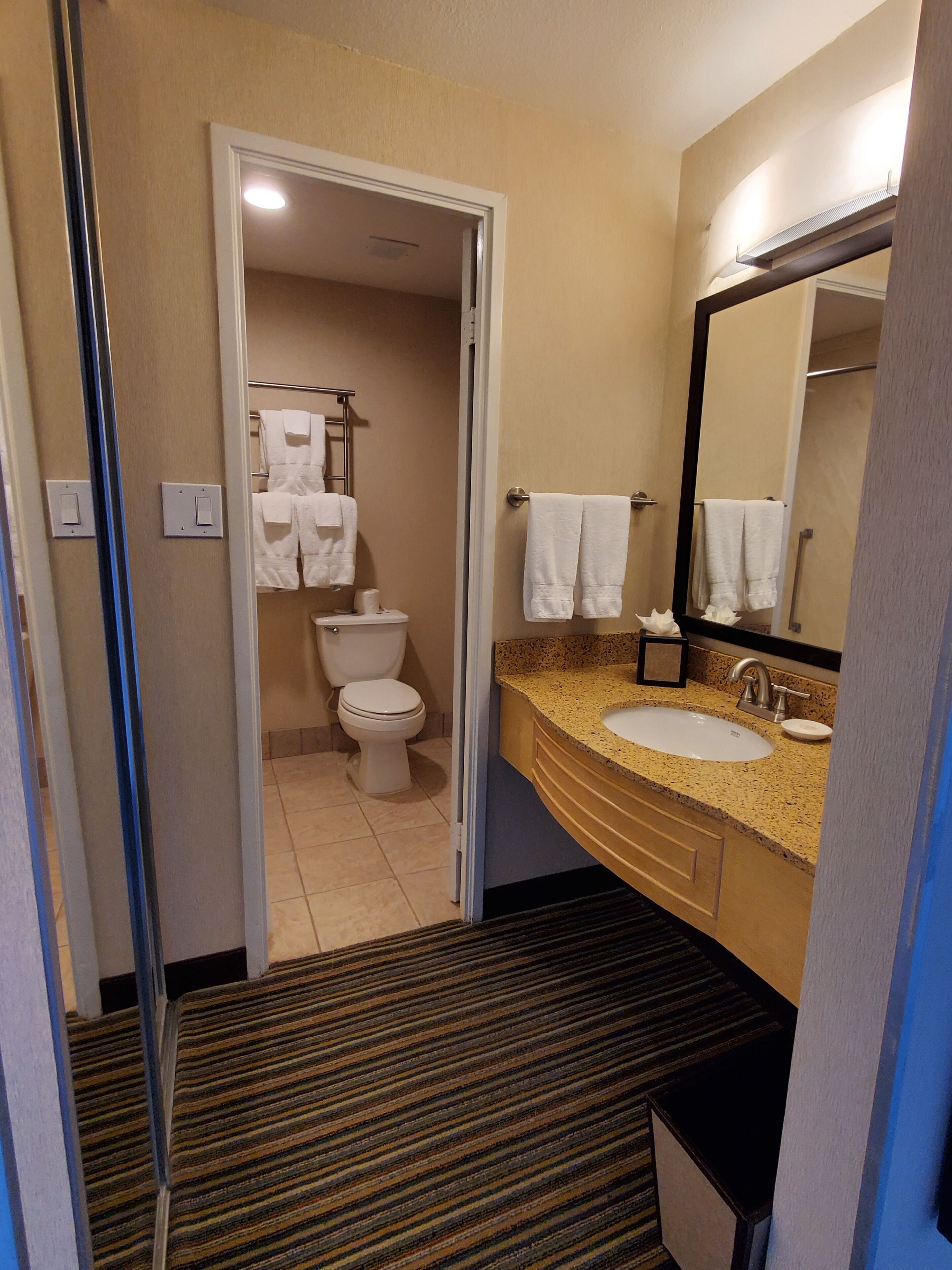 designer toiletries, hair dryer, towels, soap