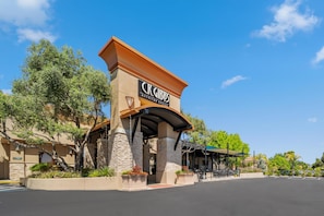 A hotel entrance with a sign reading "CR. Gibbs American Grill."