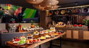 A buffet with a variety of fruits, vegetables, and dishes.