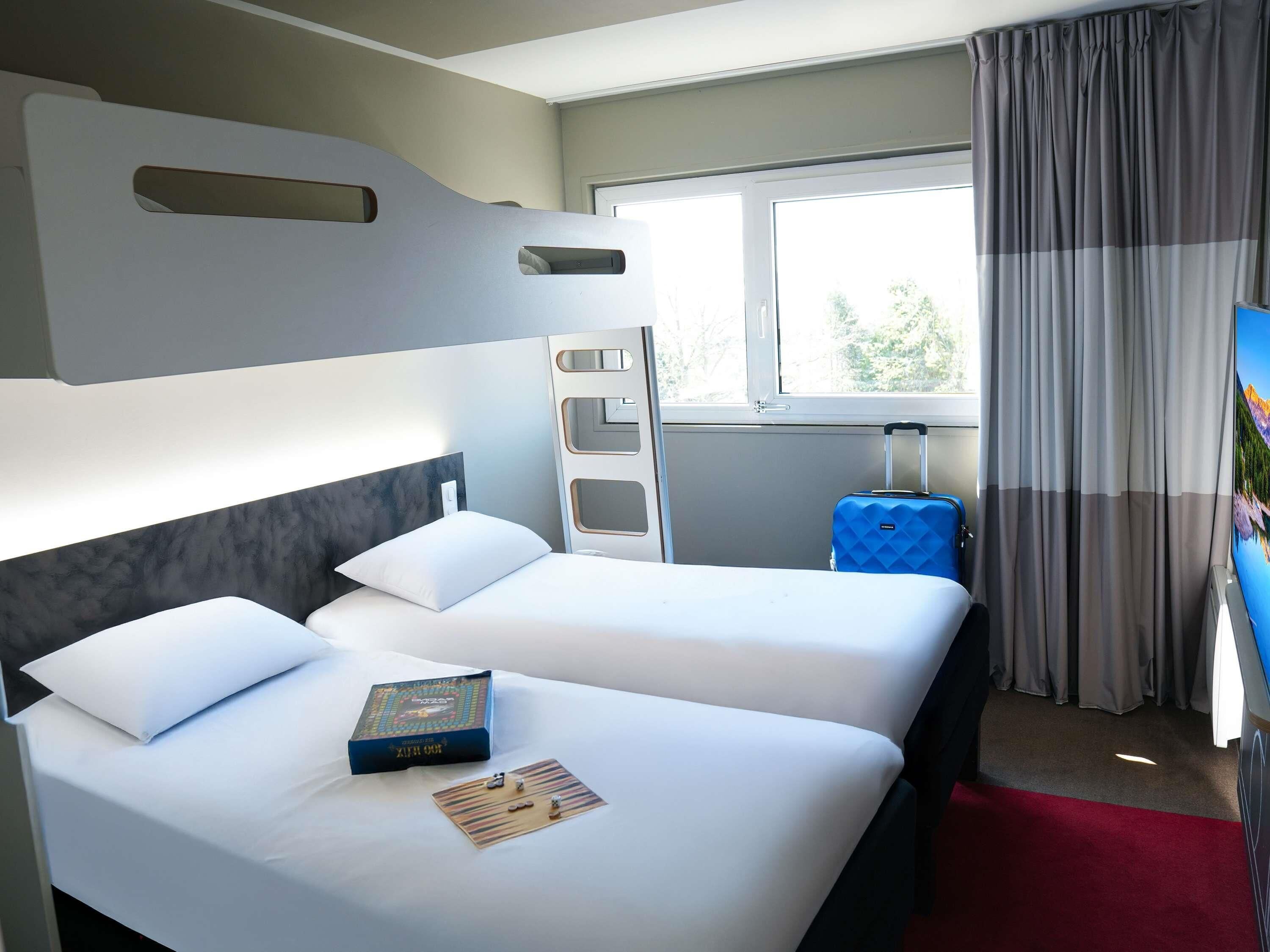family suite, multiple beds | premium bedding, desk, laptop workspace, blackout curtains