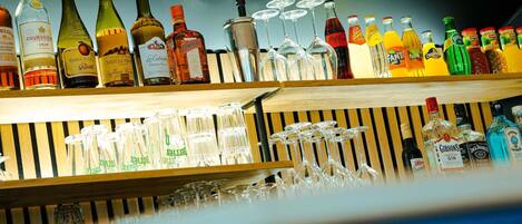 A bar area with various liquor bottles and glasses.