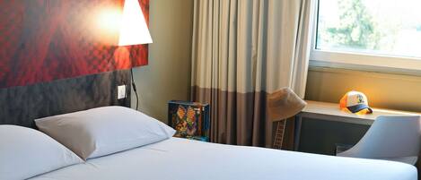 Premium bedding, desk, laptop workspace, blackout curtains