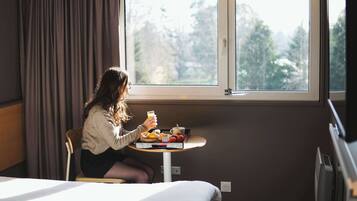 Premium bedding, desk, laptop workspace, blackout curtains