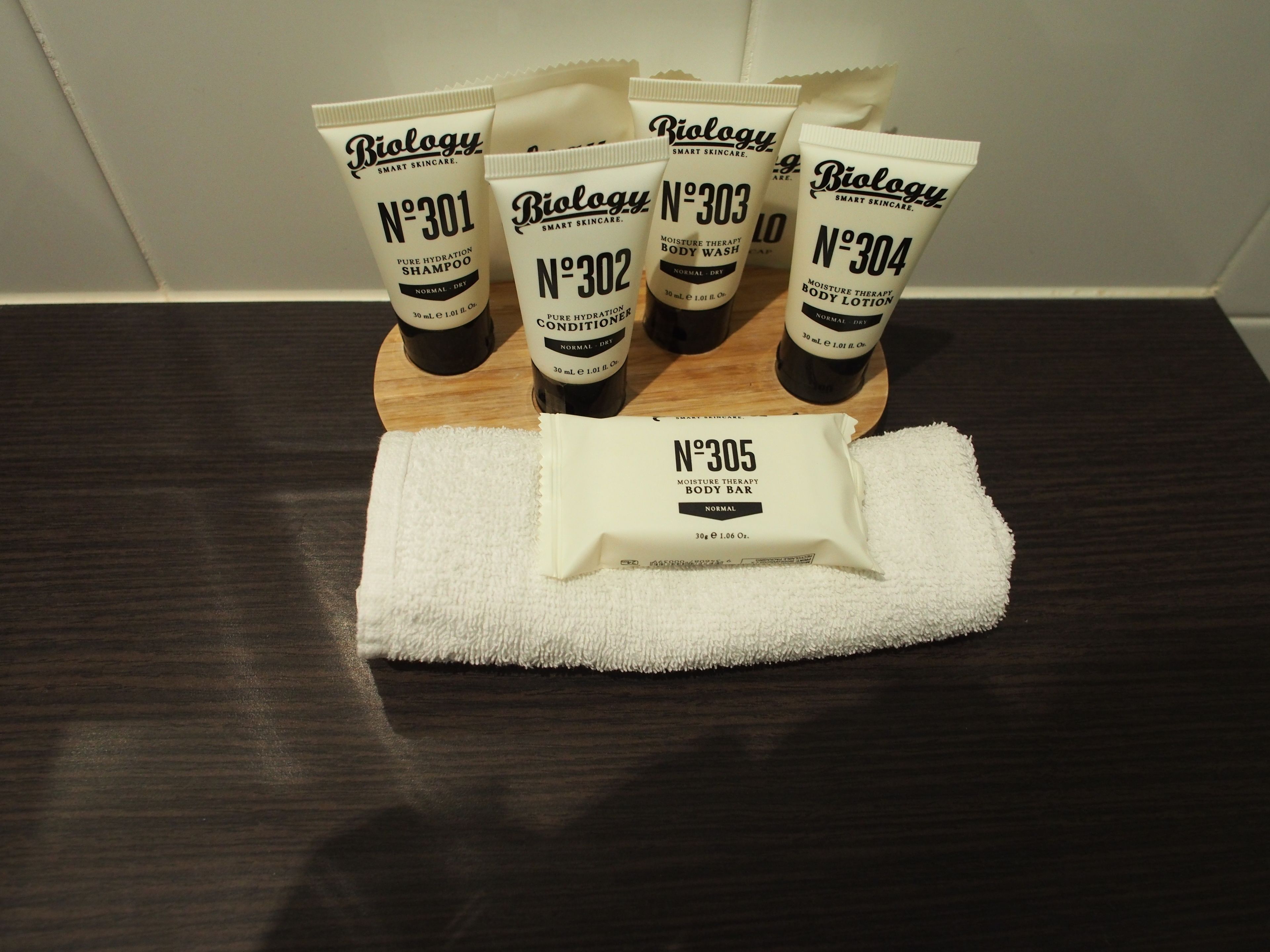 designer toiletries, hair dryer, bathrobes, slippers
