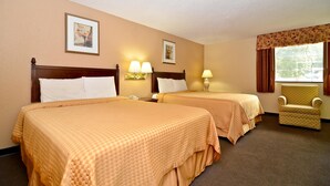 Een hotelkamer met twee bedden, een stoel en twee wandlampen.