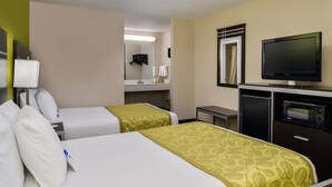 A hotel room with two beds, a TV, a desk, and a mirror. - Americas Best Value Inn Pasadena Houston (Pasadena)