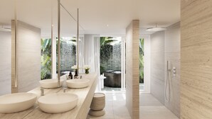 A modern bathroom with three round sinks, a large mirror, and a view of a natural landscape.