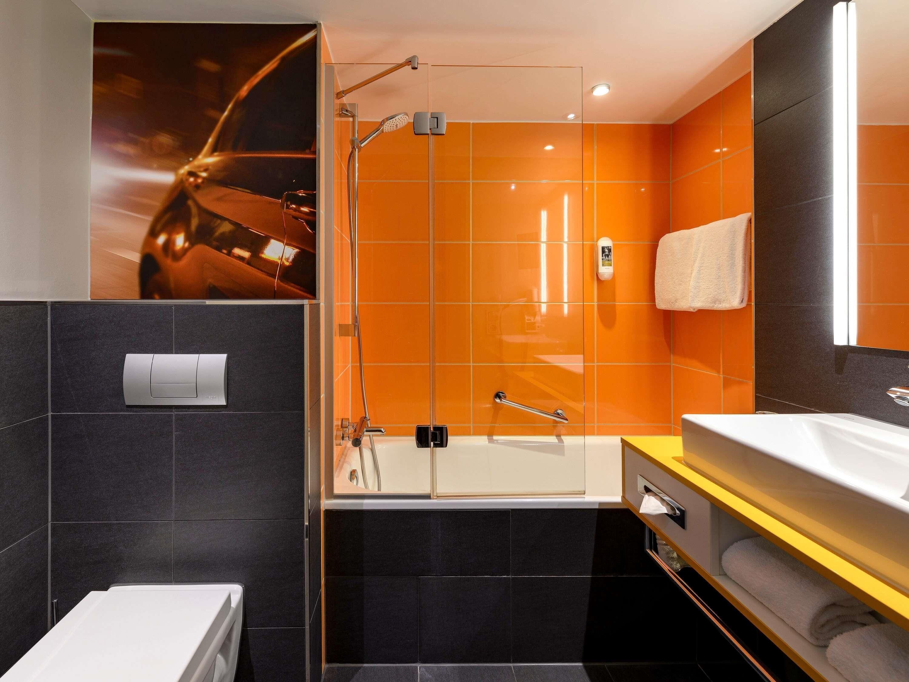 Un baño moderno con ducha, bañera y retrete.