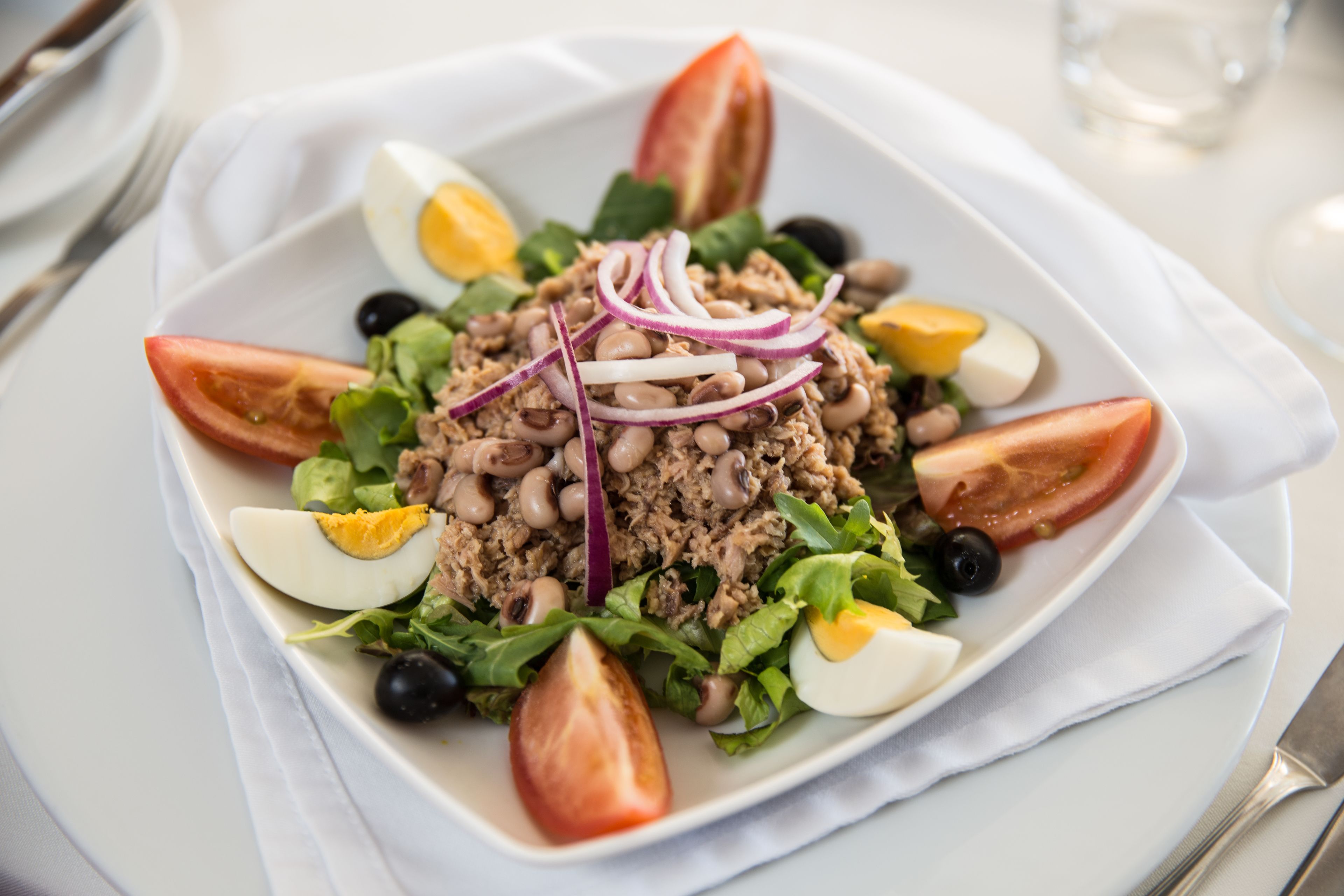 A plate of salad with various ingredients.