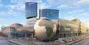 A modern building with a large glass globe sculpture in front. - Hotel Indigo Raleigh Downtown by IHG (Raleigh)