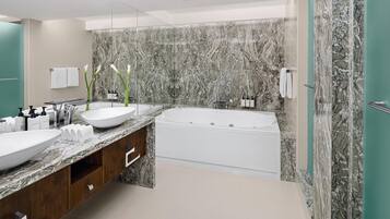 Une salle de bain moderne avec un grand lavabo en marbre, une baignoire et un meuble-lavabo doté de placards en bois.
