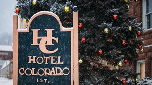 A wooden sign with the text "Hotel Colorado" and "EST. 1893" indicating the hotel's name and establishment year. - Hotel Colorado (Glenwood Springs)