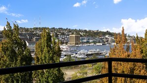 A marina with boats, a cityscape in the background, and a clear blue sky.
