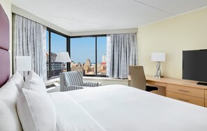 A hotel room with a large bed, a desk, a chair, and a television. - DoubleTree by Hilton Philadelphia Center City (Philadelphia)