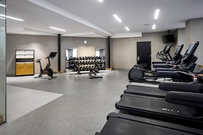 A gym with treadmills, stationary bikes, and dumbbells. - DoubleTree by Hilton Philadelphia Center City (Philadelphia)
