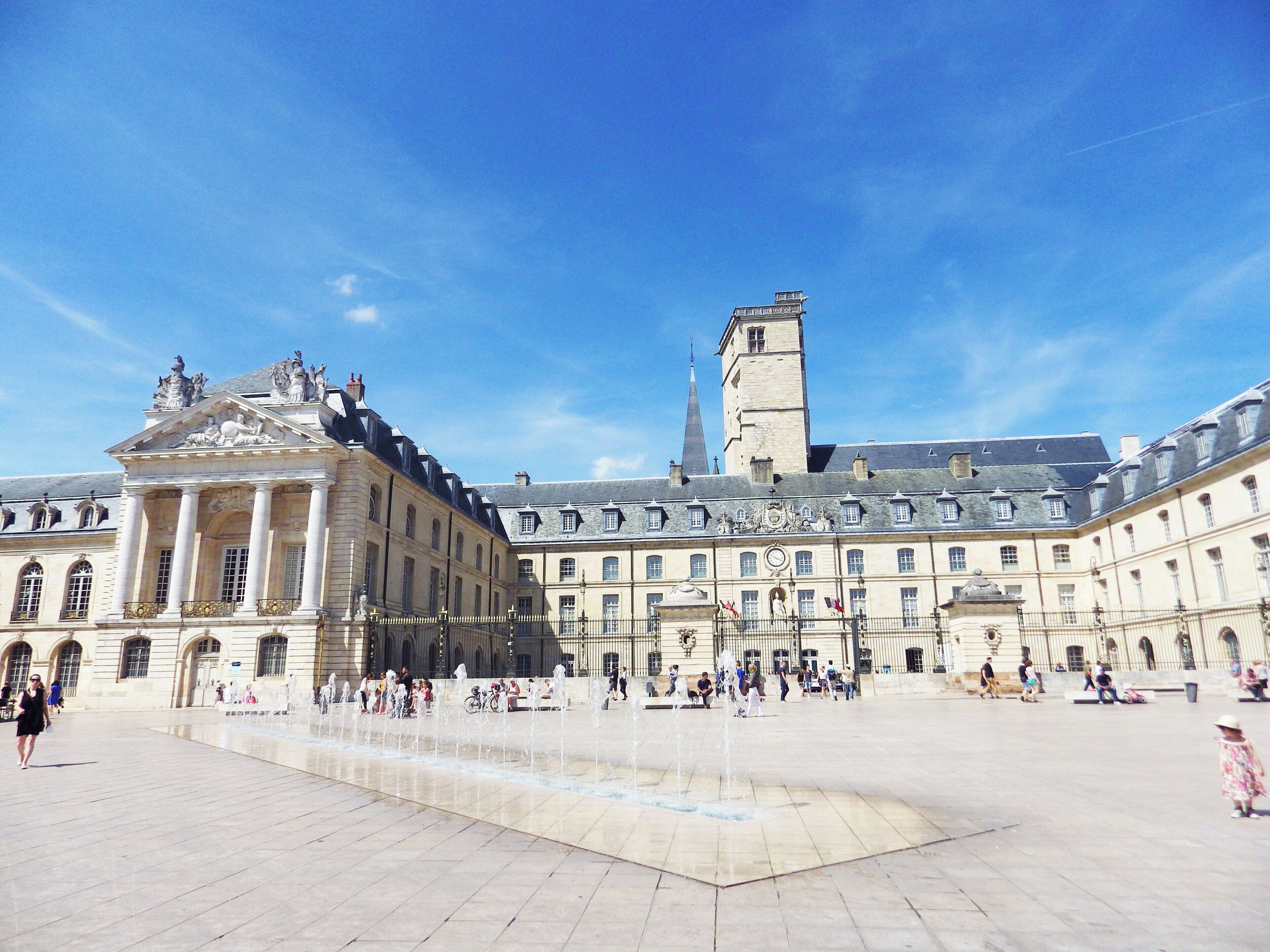 A historic building with classical architecture, a central courtyard, and a fountain.