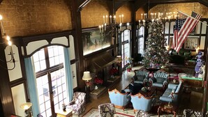 A spacious living room with a large Christmas tree, comfortable seating, and a fireplace. - Eureka Inn, Trademark Collection by Wyndham (Eureka)