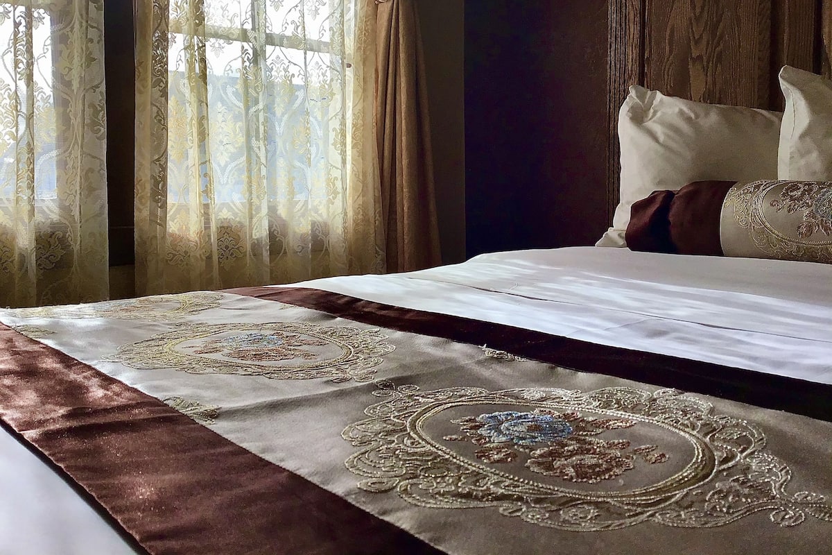 Desk, iron/ironing board, bed sheets