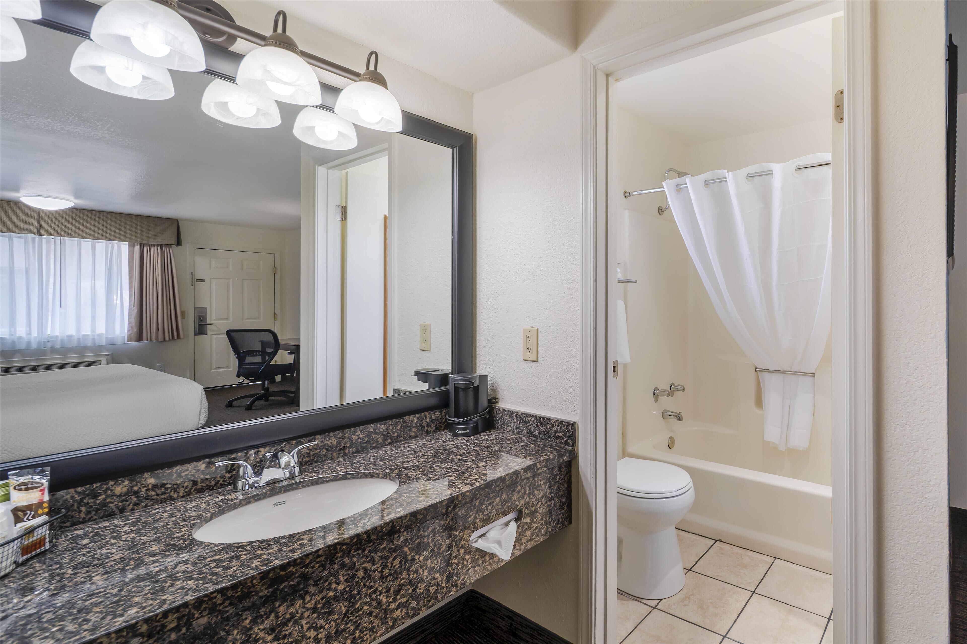 standard room, 1 king bed, non smoking, refrigerator & microwave | bathroom | combined shower/bathtub, free toiletries, hair dryer, towels