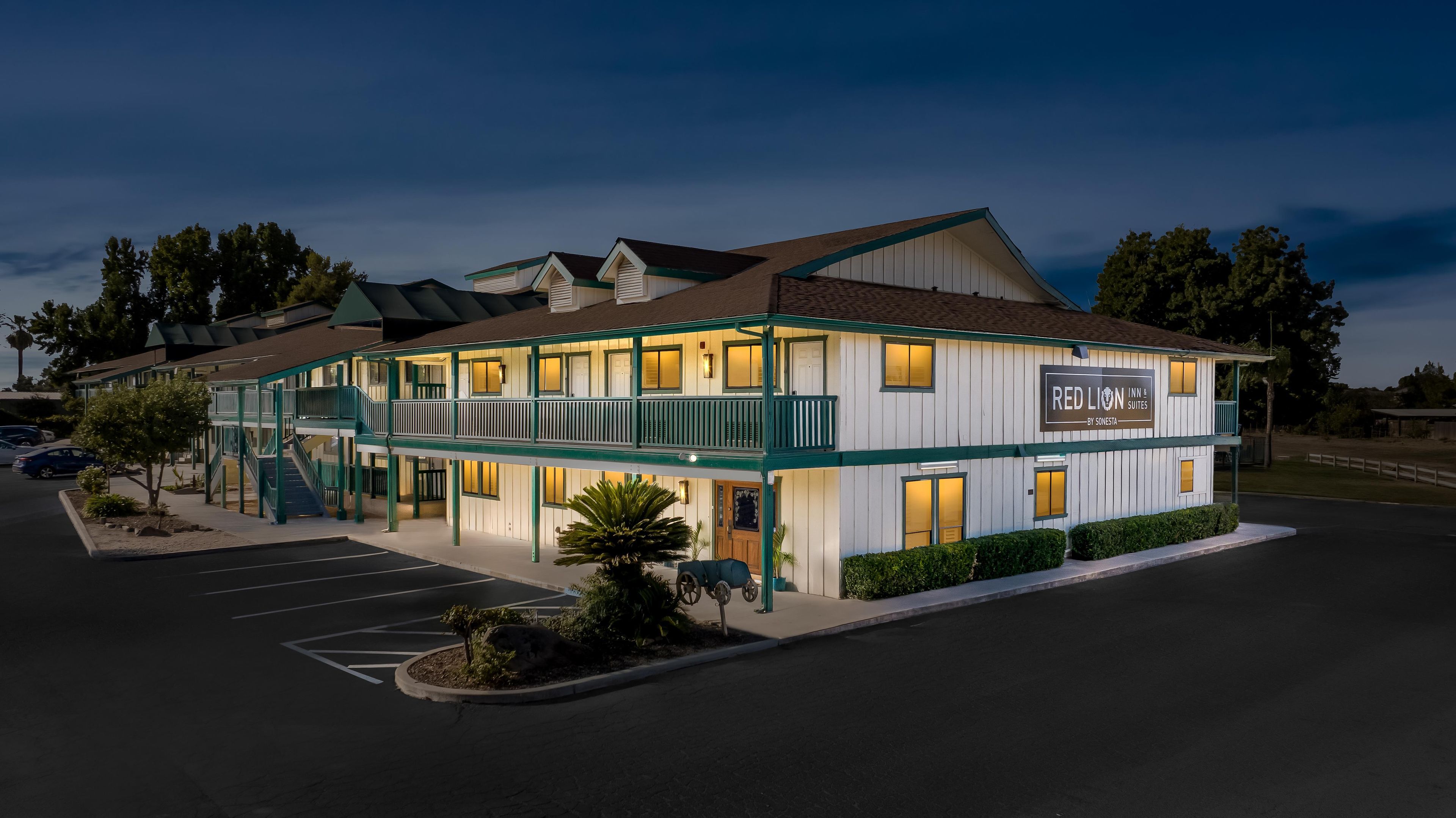 A two-story building with a sign for 'Red Lion Inn Suites' by Sonesta.