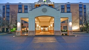 A Hyatt Place hotel entrance with a modern design, featuring a prominent archway and illuminated signage. - Hyatt Place Columbus/Worthington (Columbus)