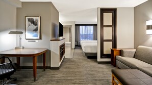 A hotel room with a desk, a television, a sofa, and a bed. - Hyatt Place Columbus/Worthington (Columbus)