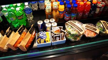 A refrigerated display case with various beverages, snacks, and packaged foods.