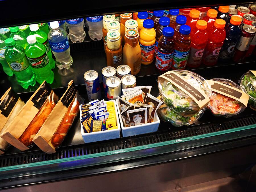 A refrigerated display case with various beverages, snacks, and packaged foods.