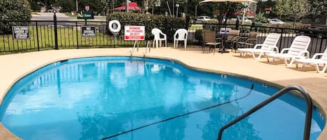 Seasonal outdoor pool, open 9:00 AM to 9:00 PM, pool umbrellas