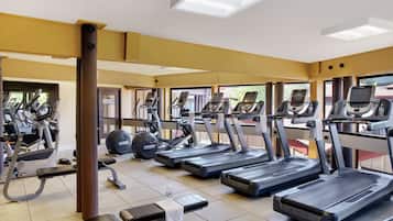 A gym with treadmills, ellipticals, and weight machines.
