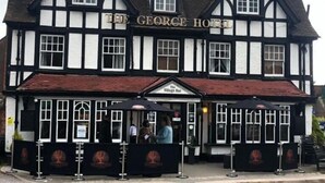 A traditional Tudor-style building with a sign reading 'The George Hotel.' - The George Hotel (Reading)