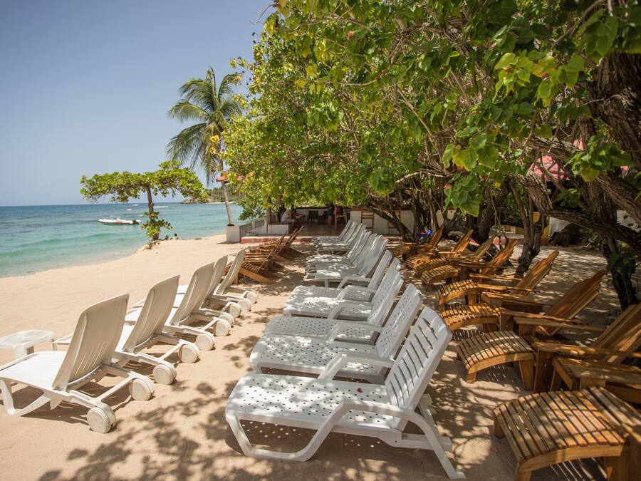 On the beach, white sand, sun-loungers, beach towels