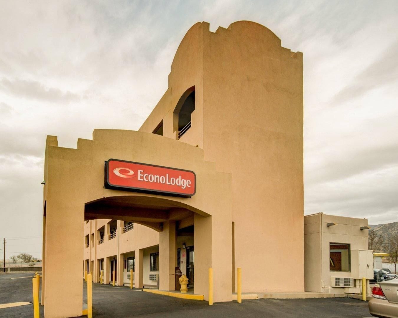 A hotel with a distinctive architectural design, featuring a large central tower and a sign for EconoLodge.