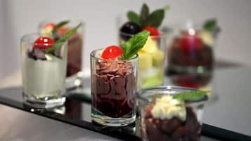 A series of dessert glasses with various toppings and garnishes.
