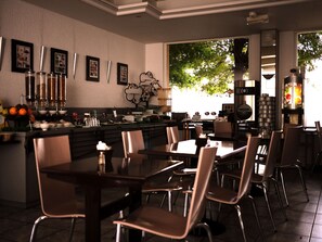 Enjoy a meal in our restaurant with a bar area, seating, and a view of the outdoors.