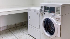 Een commerciële wasmachine met een digitaal display, bedieningsinstructies en een bedieningspaneel.