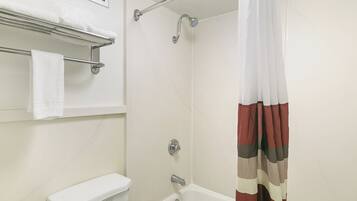 A bathroom with a shower, toilet, and towel rack.