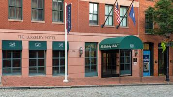The Berkeley Hotel with a brick facade, multiple windows, and a green awning.