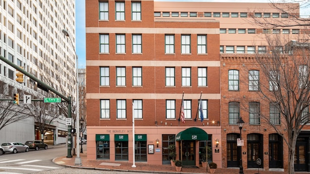 A multi-story hotel with a brick facade, large windows, and a green awning. - The Berkeley Richmond, Outset Collection by Hilton (Richmond)