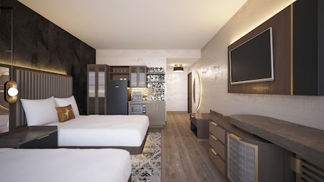 A modern hotel room with two beds, a kitchenette, a large TV, and a unique wall design.. The Berkeley Richmond, Outset Collection by Hilton