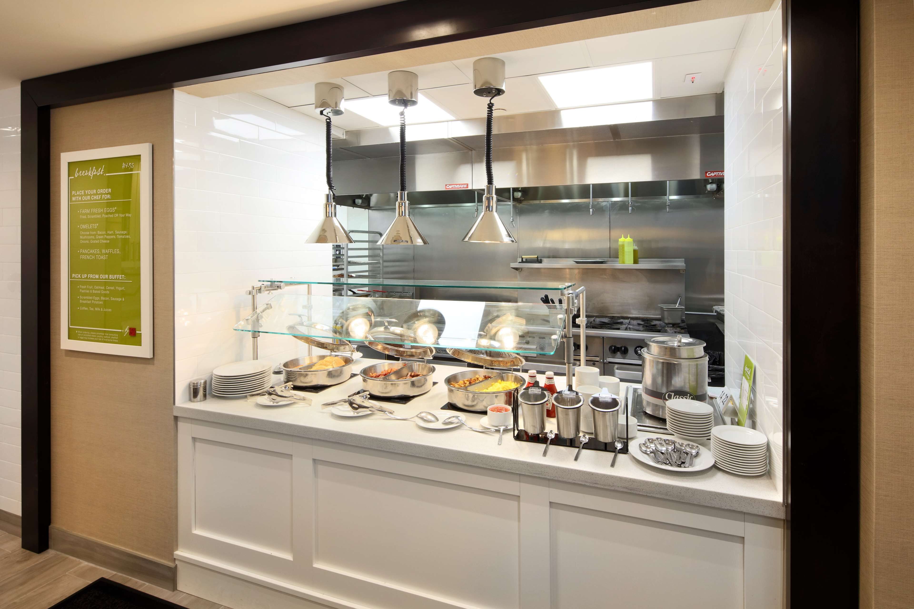 A buffet setup with various food items and condiments.
