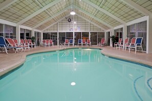An indoor swimming pool with multiple lounge chairs and a high, arched ceiling. - Holiday Inn Portsmouth by IHG (Portsmouth)