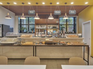 A bakery counter with various baked goods and a coffee station. - B&B Hotel Cremona (Cremona)