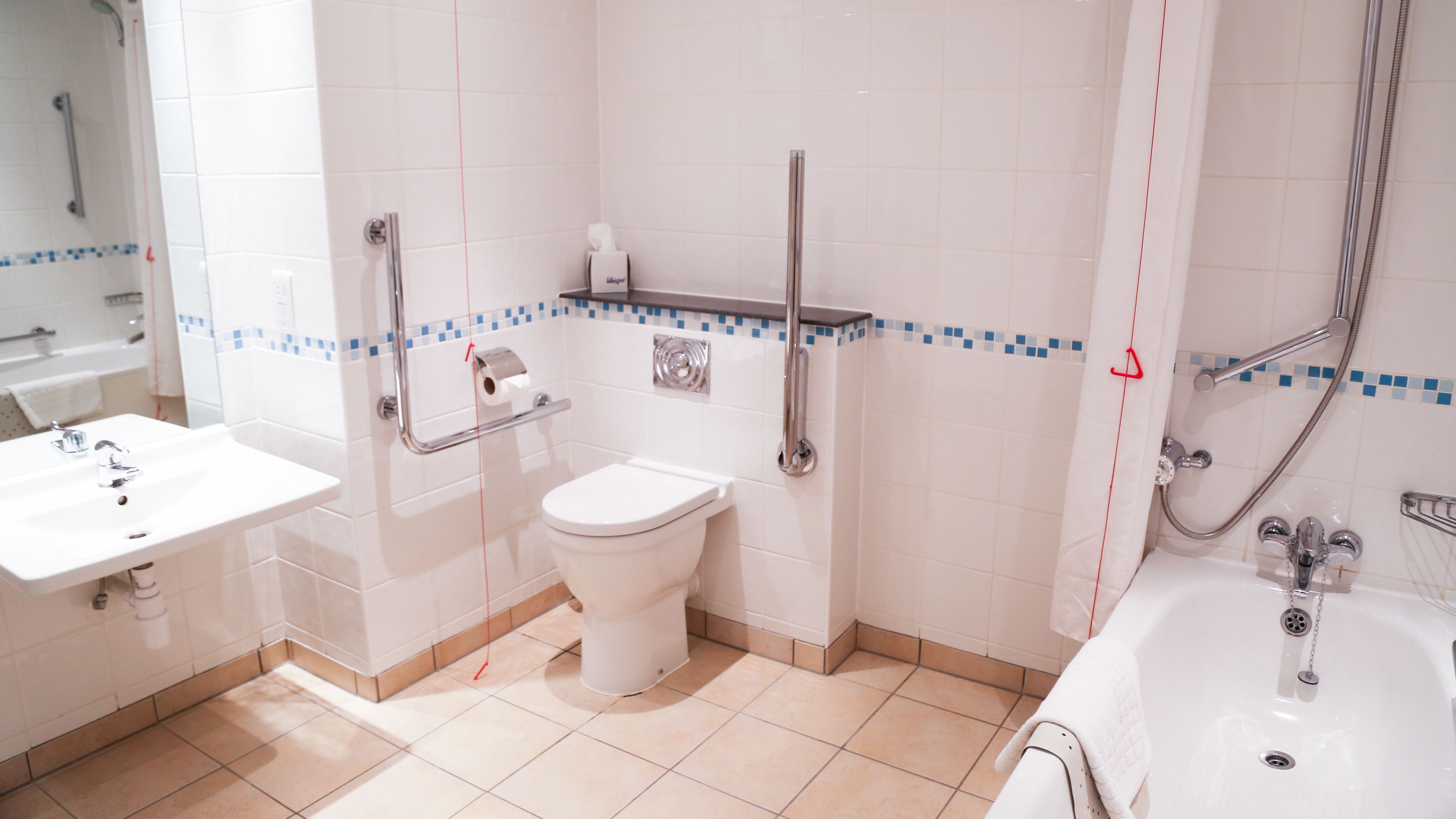 A bathroom with a toilet, sink, and bathtub.
