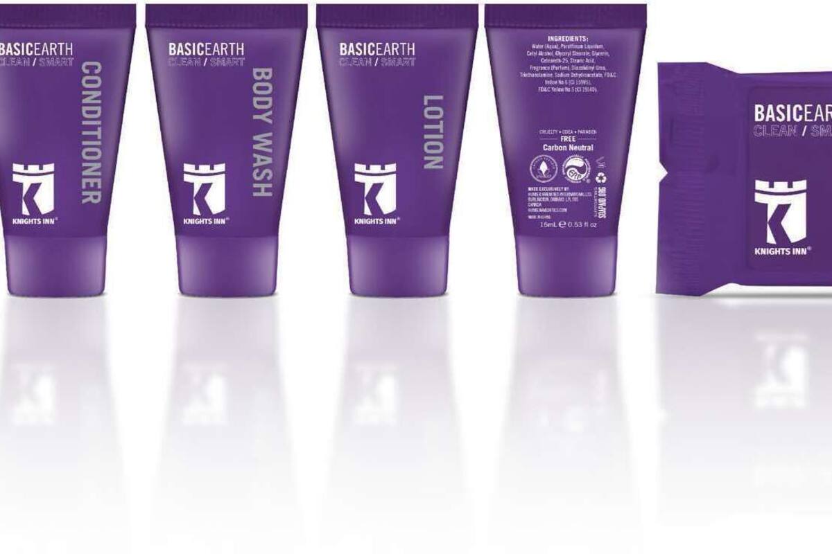 A row of purple tubes labeled 'BASICEARTH' with different product names like 'SHAMPOO', 'CONDITIONER', 'BODY WASH', 'LOTION', and a 'CLEANSING BAR'.