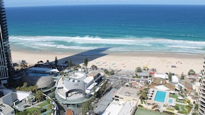 A beachfront hotel with a pool, beach access, and a view of the ocean. - Novotel Surfers Paradise (Surfers Paradise)