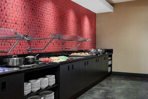 A buffet setup with various food items and utensils. - Buffalo Marriott Niagara (Buffalo)