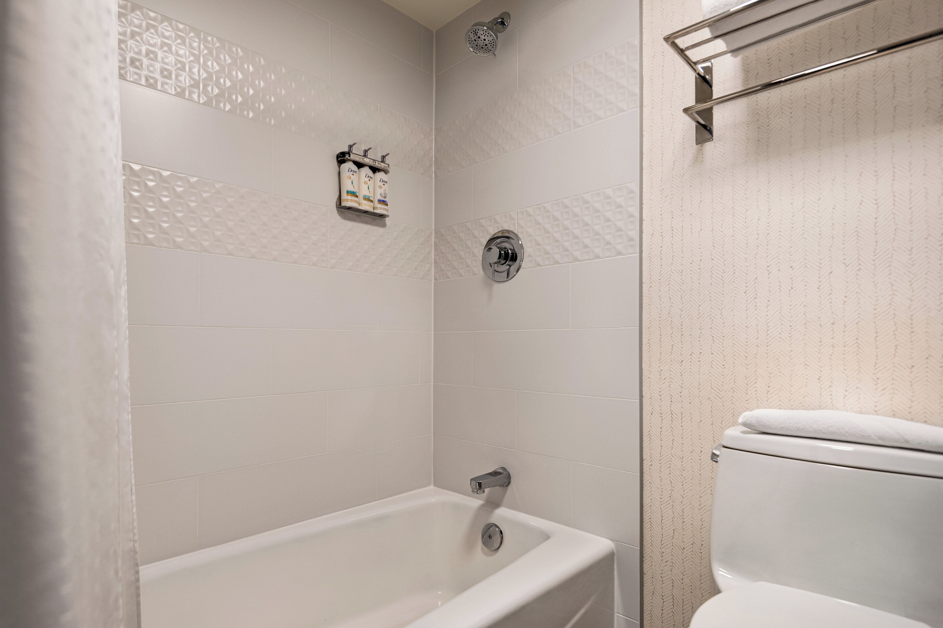 A bathroom with a bathtub, a shower, and a toilet.